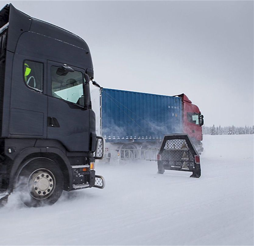 Figure 4. A controlled road test of the AEBS software. The trapezoidal object between the two vehicles is a “soft target” designed to resemble a vehicle that is used to “fool” the radar and the camera.